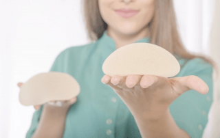 Woman Holding Two Breast Implants