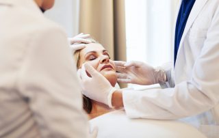 Doctor Examining a Woman's Face Atlanta's Best Facelift Surgeon | Facelift Atlanta & Alpharetta | Dr Zubowicz