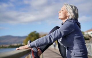 Older woman stretching outside Atlanta Plastic Surgery Blog | Dr Vincent Zubowicz MD